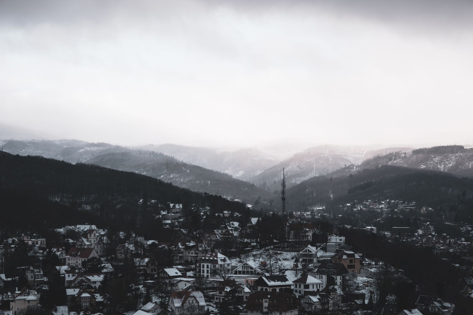 A snowy village between mountains