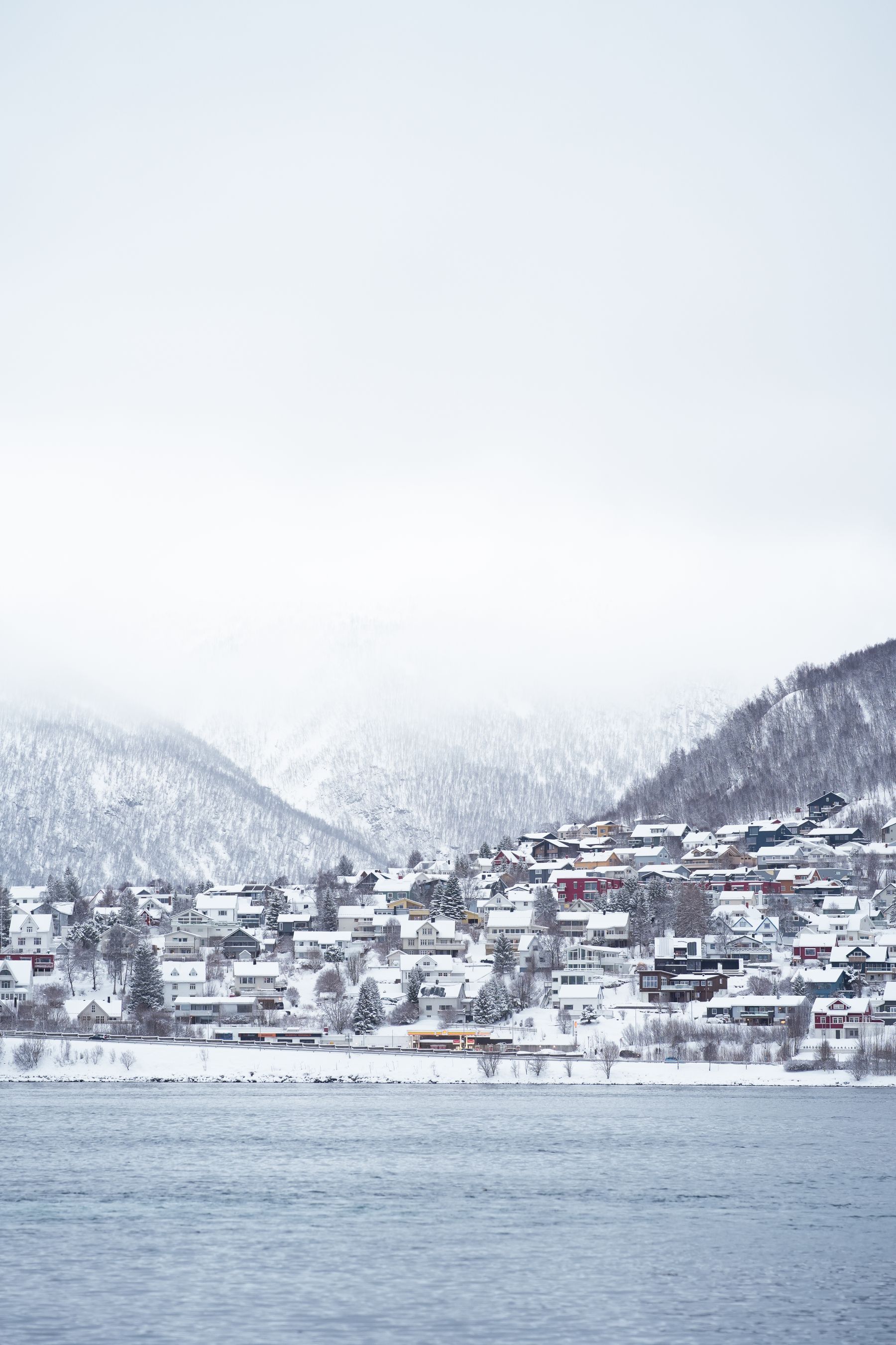 A mountain town on the water at dusk